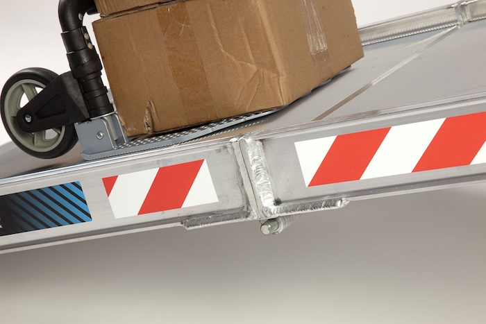 Trolley going up aluminium van ramp