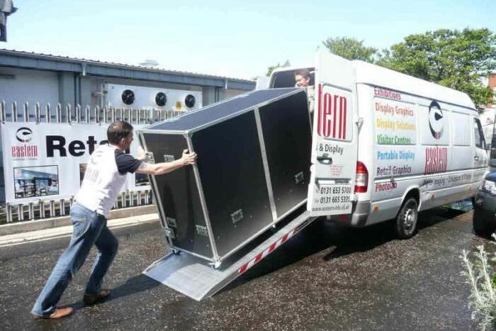Person pushing flightcase into van 