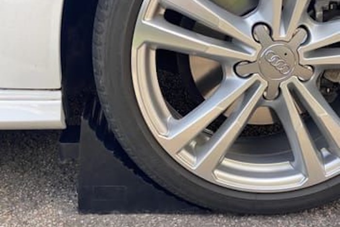 Car infront of rubber wheel chock 